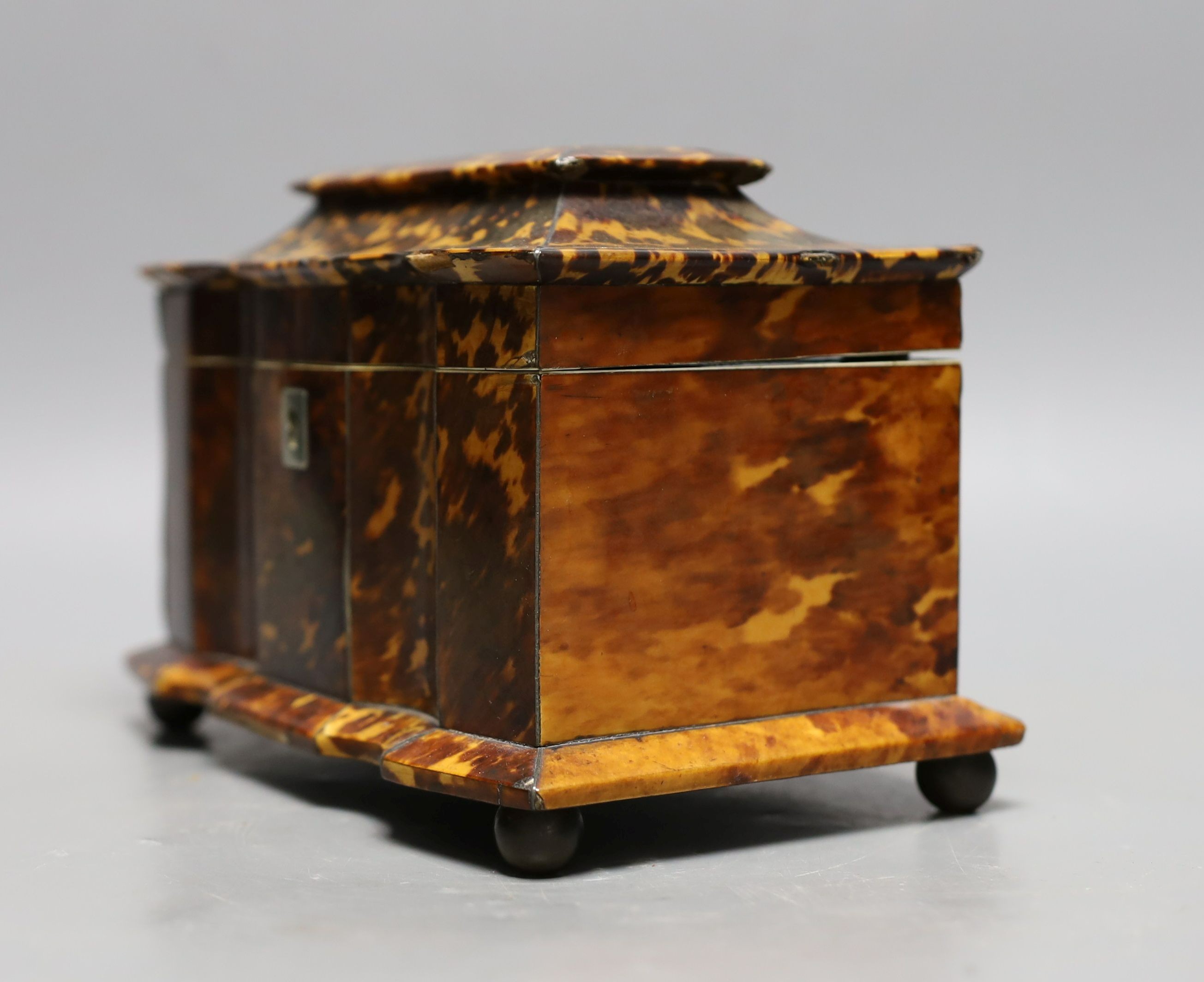 A 19th century tortoiseshell veneered tea caddy, ivory veneered edging, 20cms wide